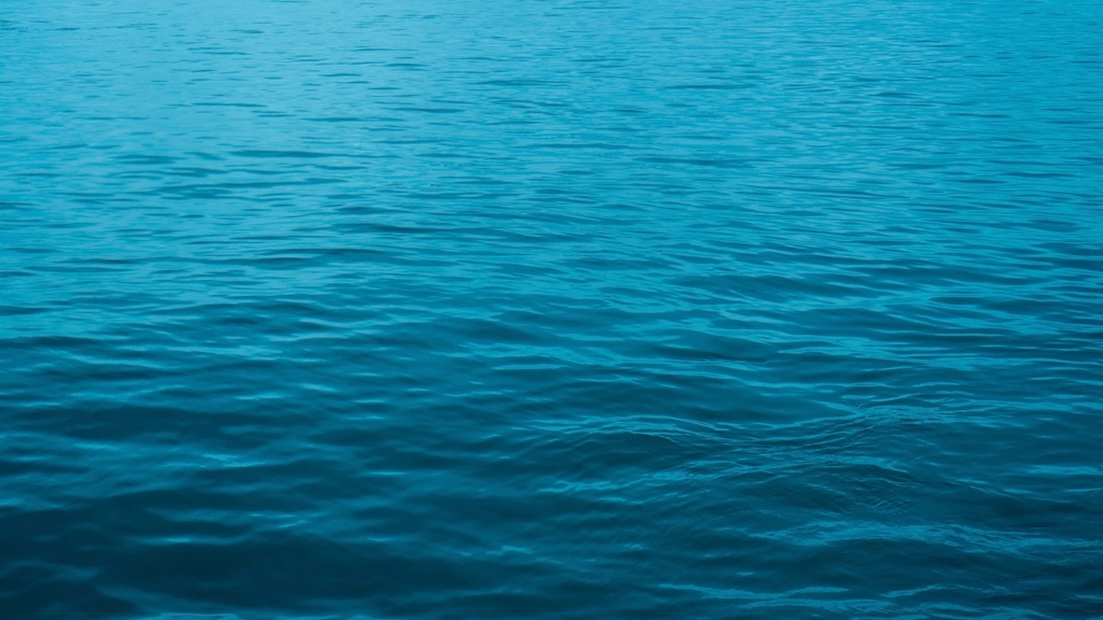 Close-up of deep blue ocean water with gentle ripples, no shoreline or horizon visible