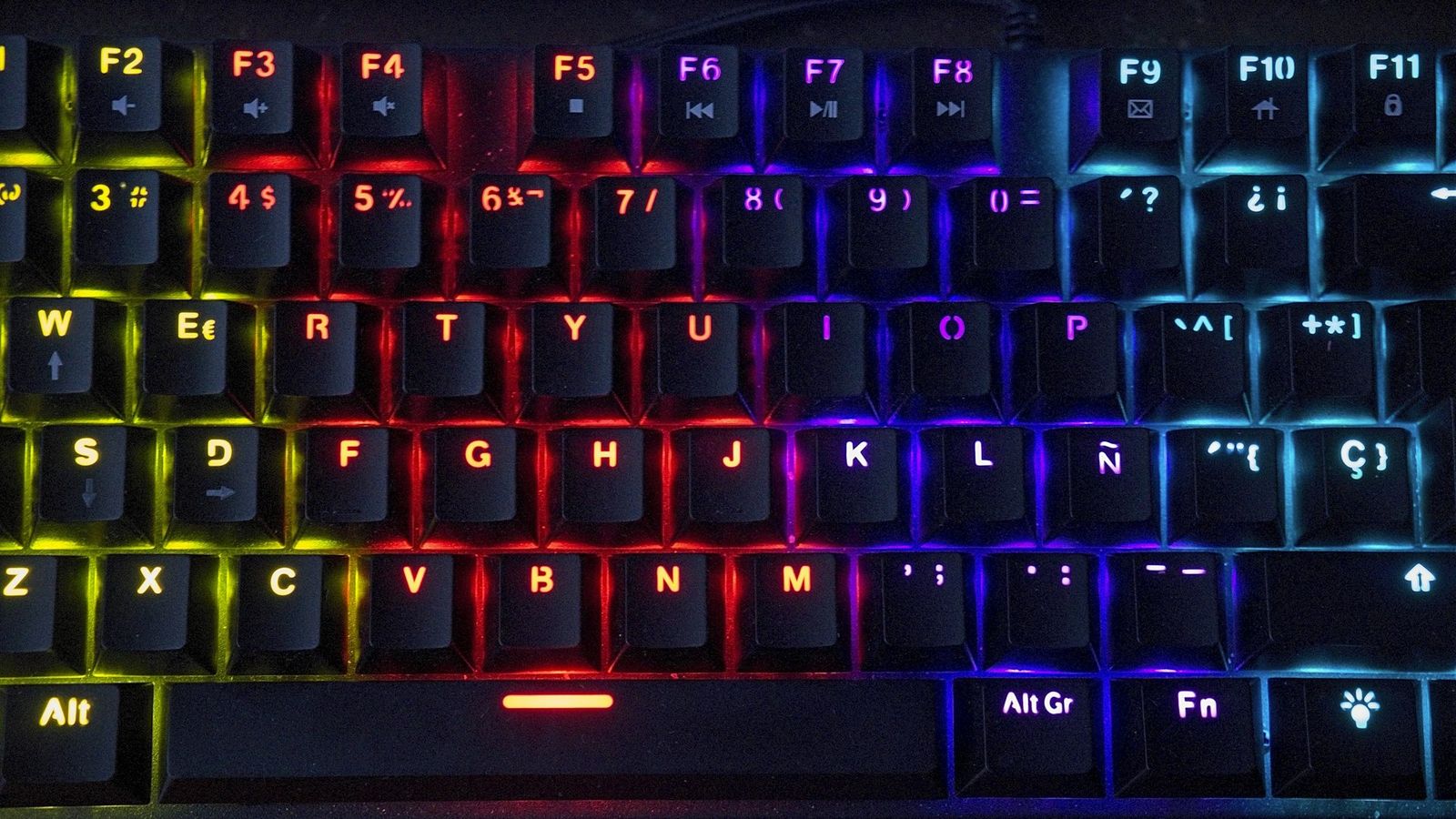 Close-up of a mechanical keyboard with rainbow RGB backlighting